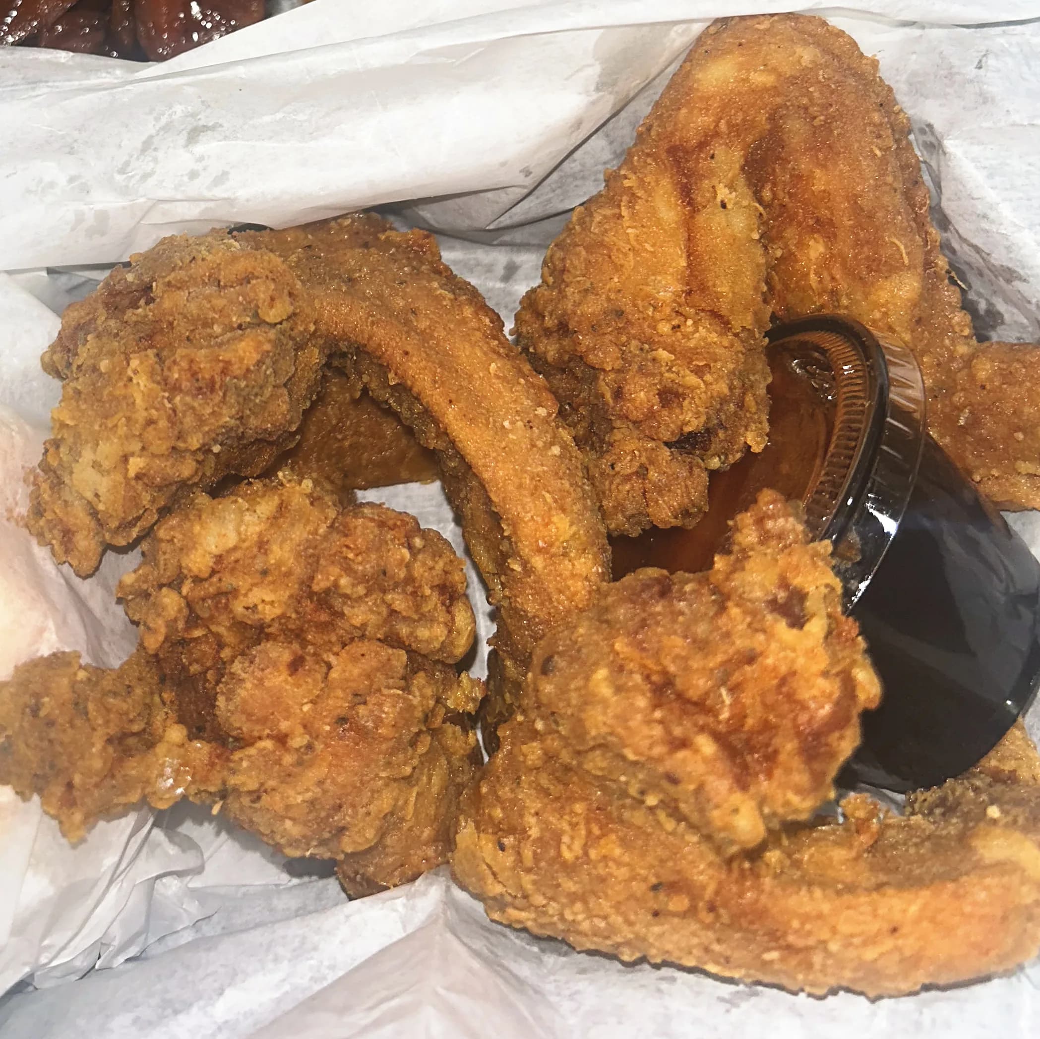 Close-up of crispy fried whole wings with dipping sauce